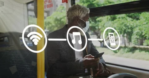 Animation of application icons over senior african american man wearing mask and Stock Footage 329295899