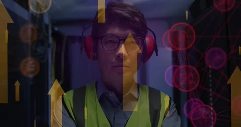 Animation of arrows and icons over asian male it engineer with headphones by Stock Footage 329015677