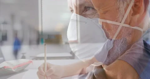 Animation of asian boy writing over senior caucasian man with face mask Stock Footage 199334741
