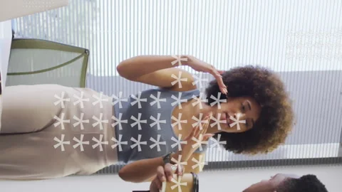 Animation of asterisks forming arrows over multiracial coworkers discussing over Stock Footage 313166259