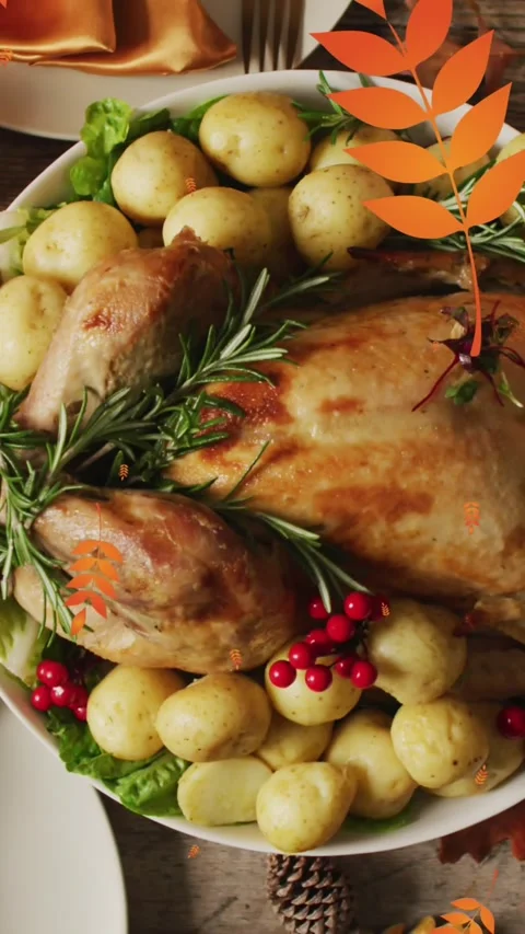 Animation of autumn leaves falling over thanksgiving dinner background Stock Footage 343609816