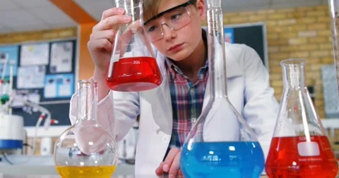 Animation of bat icon over caucasian schoolboy at science class Stock Footage 329688520