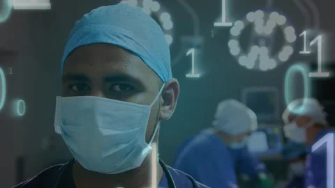 Animation of binary code moving over male surgeon in face mask 動画素材 326425918