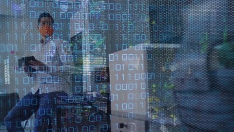 Animation of binary code over caucasian man in face mask in office 動画素材 329367869