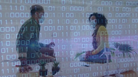 Animation of binary code over diverse coworkers in face masks in office 動画素材 329926010