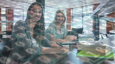 Animation of binary code over smiling caucasian coworkers working in library Stock Footage 327125645