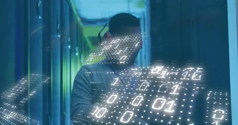 Animation of binary codes, african american male engineer using laptop in server Stock Footage 247966015
