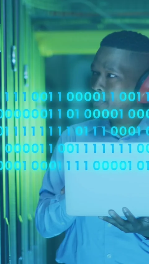 Animation of binary codes, african american engineer with headphone and laptop Stock Footage 343779974