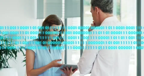 Animation of binary codes over caucasian coworkers discussing reports on digital Stock Footage 250591948