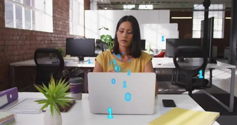 Animation of binary codes over thoughtful biracial woman working on laptop in Stock Footage 255056991