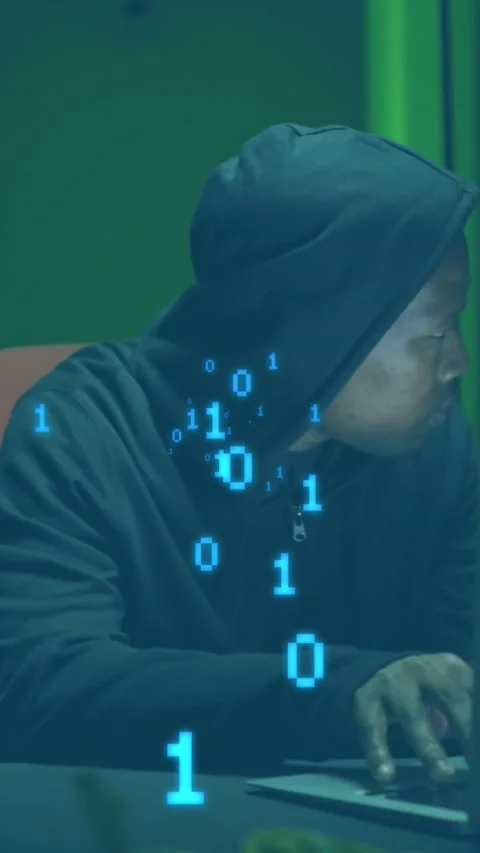 Animation of binary coding against african american male hacker using laptop at 库存影片 344723234