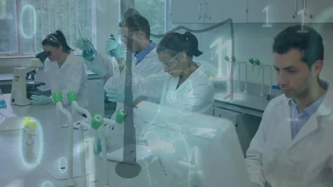 Animation of binary coding, data processing over diverse scientists in Stock Footage 220378375