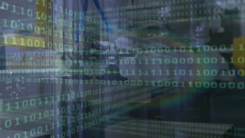 Animation of binary coding data processing over close up of machinery at the Stock Footage 325699907
