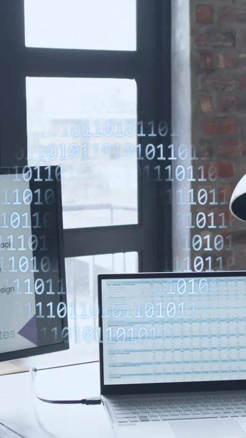 Animation of binary coding, globe and data processing over computers on desks in Stock Footage 343079223