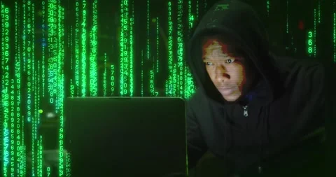 Animation of binary coding over african american male hacker using laptop in Stock Footage 237490704