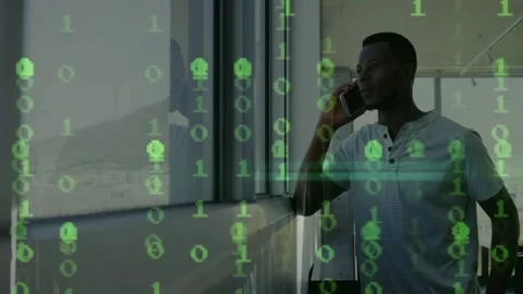 Animation of binary coding over african american man talking on smartphone Stock Footage 329368314