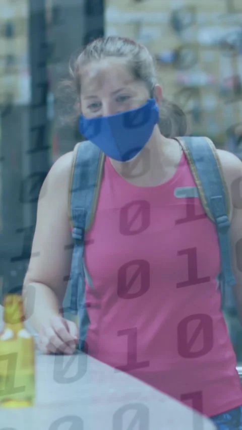 Animation of binary coding over caucasian woman with face mask disinfecting Stock Footage 324434544