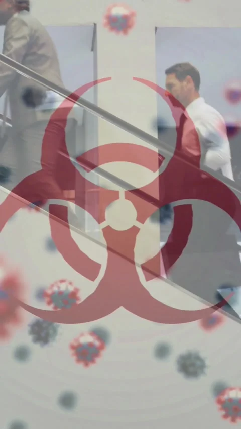 Animation of biohazard symbol and floating Covid-19 cells over people walking at Stock-Footage 343497576