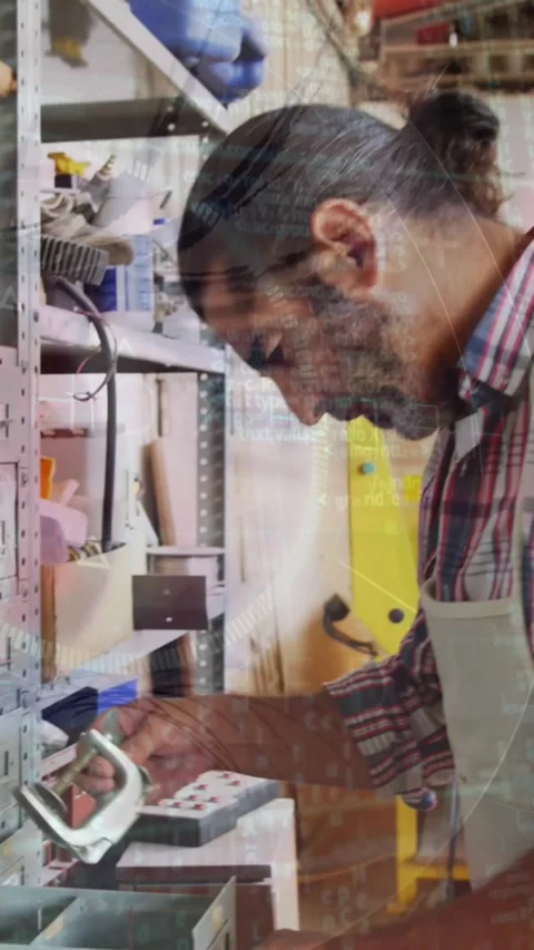 Animation of blinking eye over caucasian male carpenter working in workshop Stock Footage 343738406