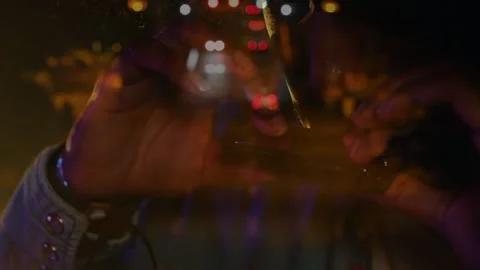 Animation of blurred night road traffic over caucasian man playing harmonica on Vidéo 330474863