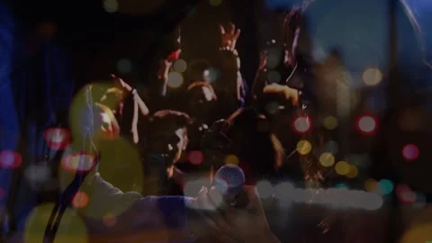 Animation on blurred night road traffic over people having fun on concert Stock Footage 330659213
