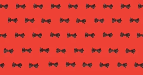 Animation of bow ties floating over red background Stock Footage 328353255