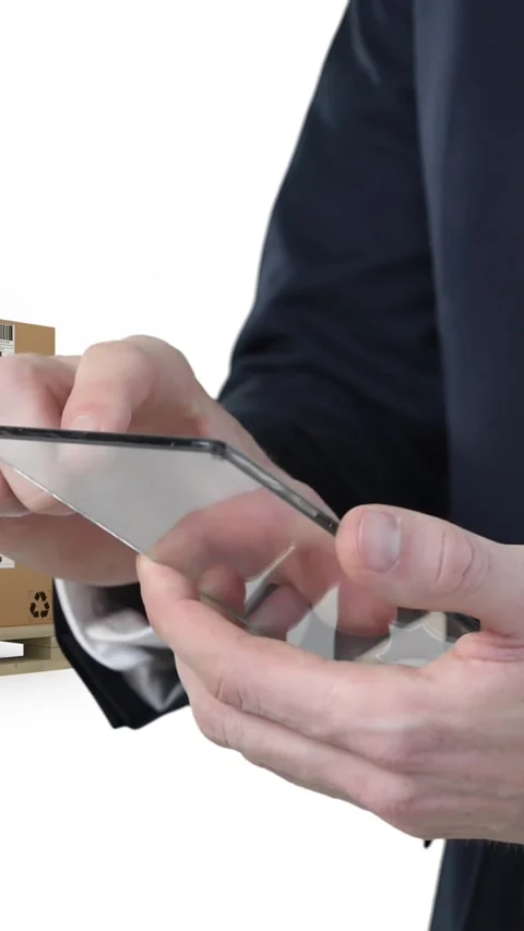 Animation of businessman using clear smartphone with stacks of boxes on white Stock Footage 331646501