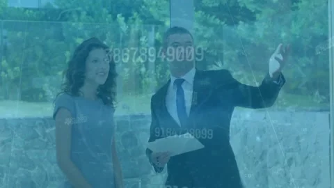 Animation of changing numbers over caucasian male real estate agent showing a Stock Footage 233301942