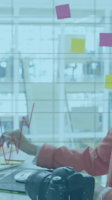 Animation of charts processing data over female creative using camera at office Stock Footage 343901919