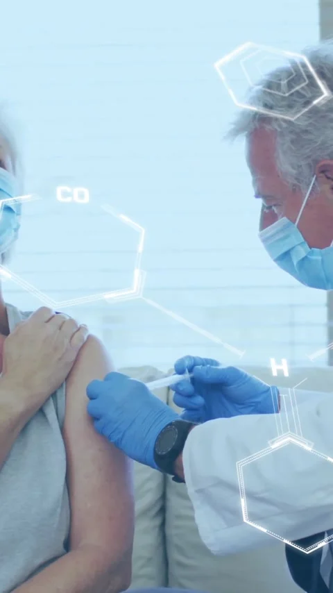 Animation of chemical formula over caucasian male doctor with patient holding Stock Footage 342812639