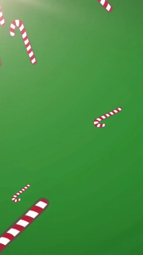 Animation of christmas candy canes decorations falling with glowing light on Stock Footage 342704847
