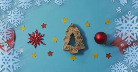 Animation of christmas snowflake pattern over christmas decorations Stock Footage 329987654