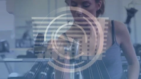Animation of clock and graph over caucasian woman lifting dumbbells on gym Stock Footage 327200702