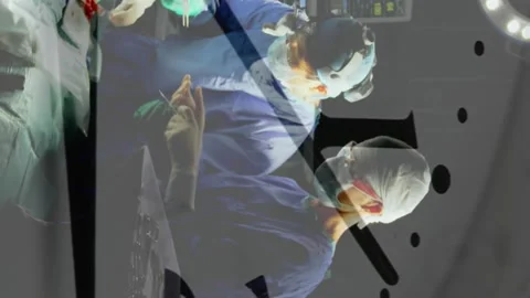 Animation of clock ticking over diverse surgeons in operating theatre Video stock 313088565