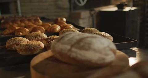 Animation of close up of fresh baked breads and rolls at bakery Stock Footage 340985881