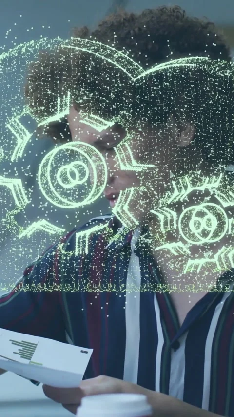 Animation of cloud with cog wheels over diverse colleagues discussing work in Stock Footage 342015580