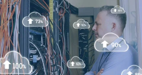 Animation of cloud icons with growing numbers over caucasian man in server room Stock Footage 330728056