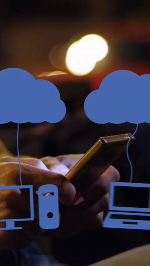 Animation of clouds with electronic devices over caucasian man using smartphone Stock Footage 344693732