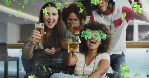 Animation of clover icons over diverse friends drinking beer Stock Footage 329158580