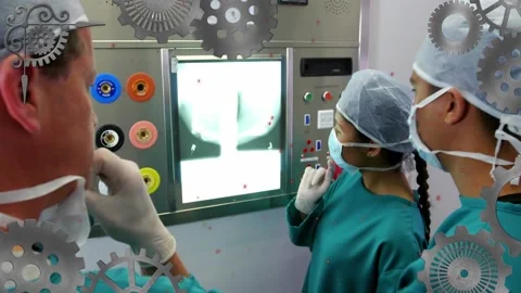 Animation of cogs moving over diverse surgeons in hospital Stock Footage 222832979