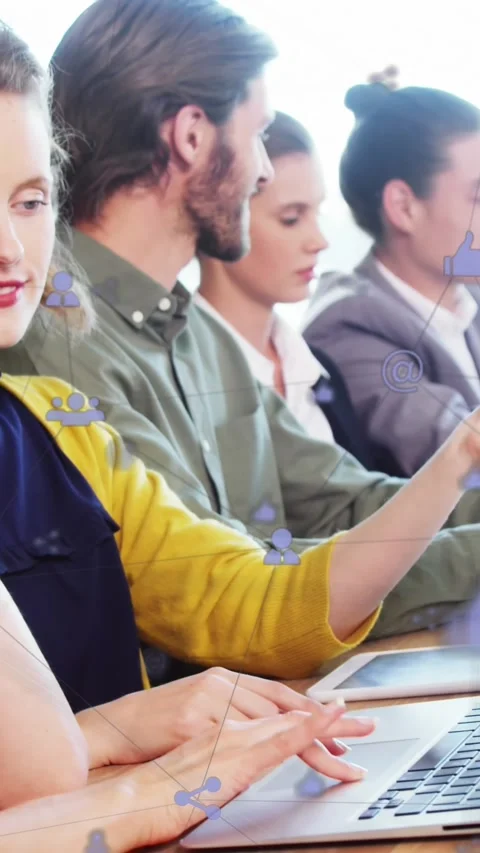 Animation of computer icons connected with lines over diverse coworkers using Stock Footage 343779133