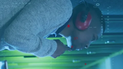 Animation of computer language, binary codes, african american man checking Stock Footage 314143899