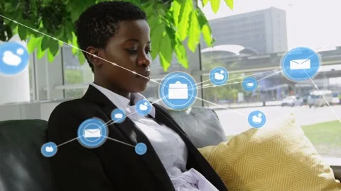 Animation of connected icon over african american businesswoman using laptop Stock Footage 327447471