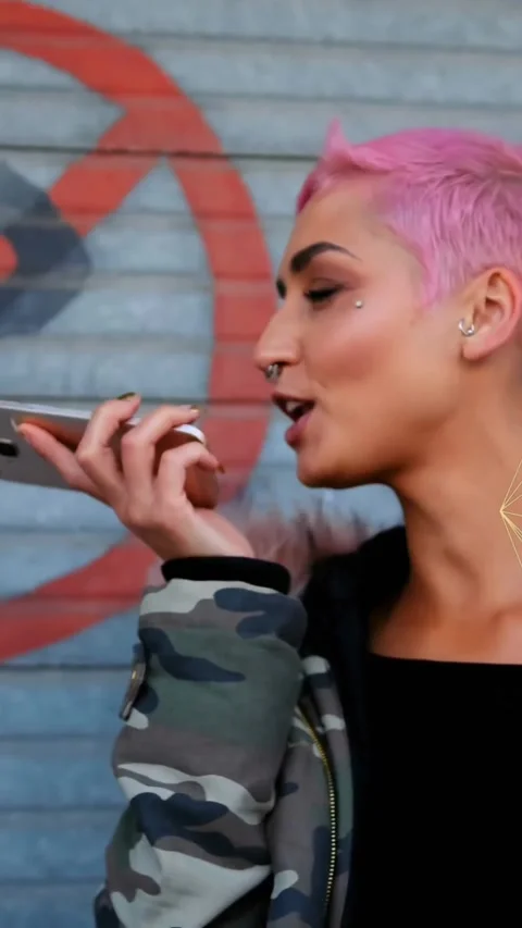 Animation of connected icons globe over woman talking on speaker of smartphone Stock Footage 323578580