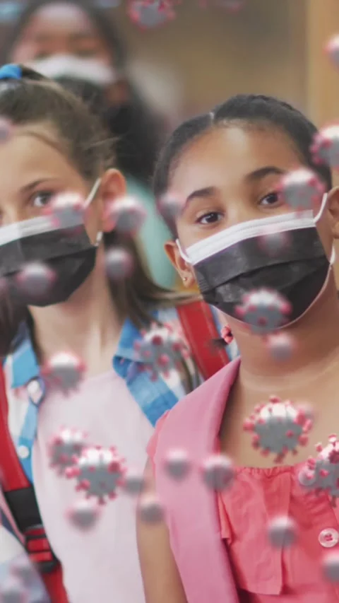Animation of covid-19 cells on group of diverse kids wearing face masks standing Stock Footage 343955661