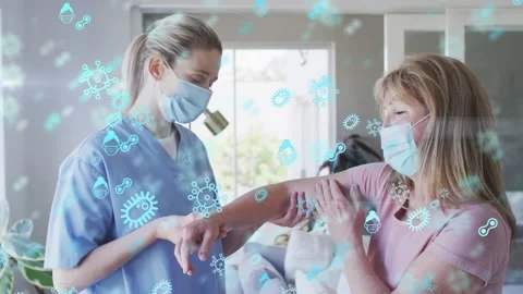 Animation of covid virus cells over caucasian senior woman and nurse wearing Stock Footage 329283068