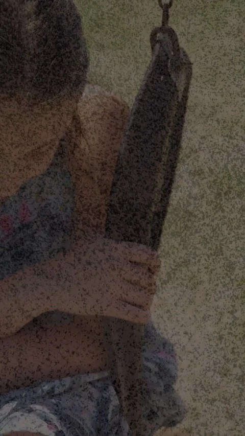 Animation of cracked texture changing over sad caucasian girls sitting on swing Stock Footage 324023541
