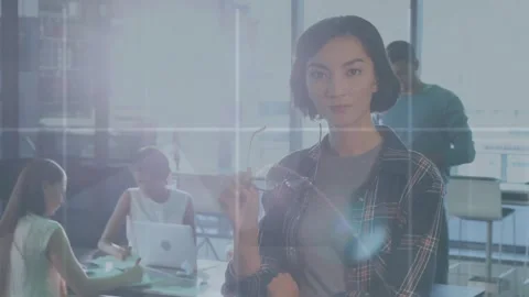 Animation of data processing against asian woman removing her glasses at office Stock Footage 241078197
