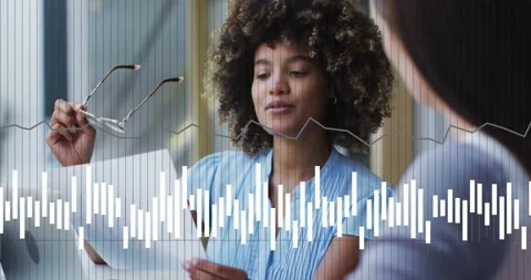 Animation of data processing and diagrams over diverse businesswomen discussing Stock Footage 328520760