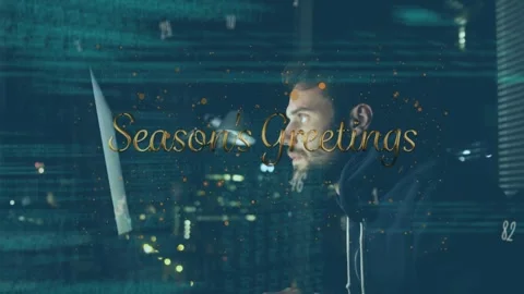Animation of data processing and season's greeting over caucasian hacker using Stock Footage 329413986